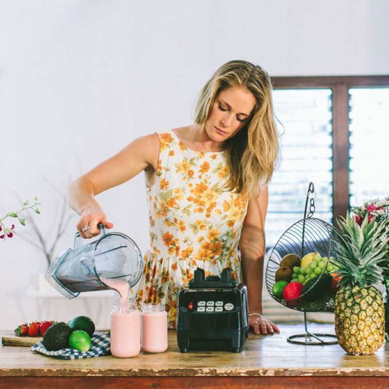 A woman pouring smoothie from the BioChef High Performance Blender