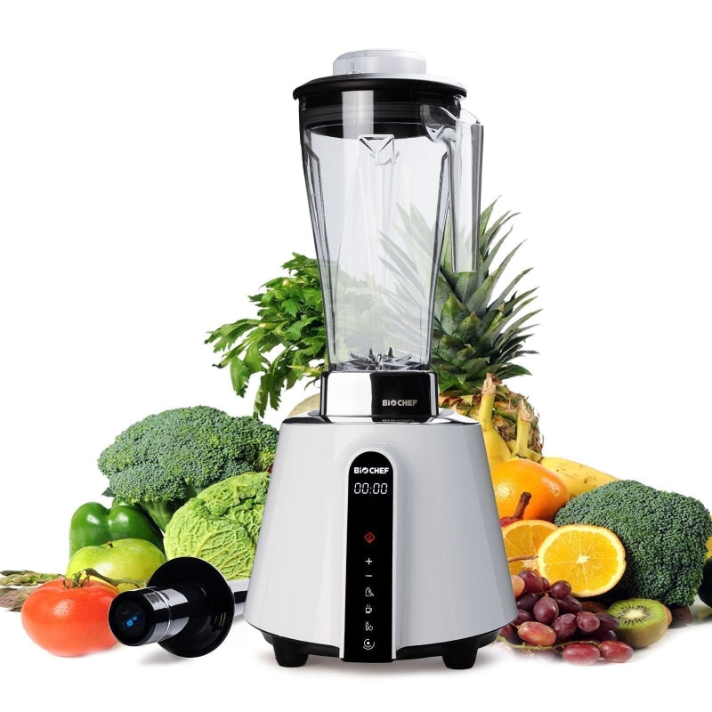 White BioChef Living Food Blender with fruits behind it