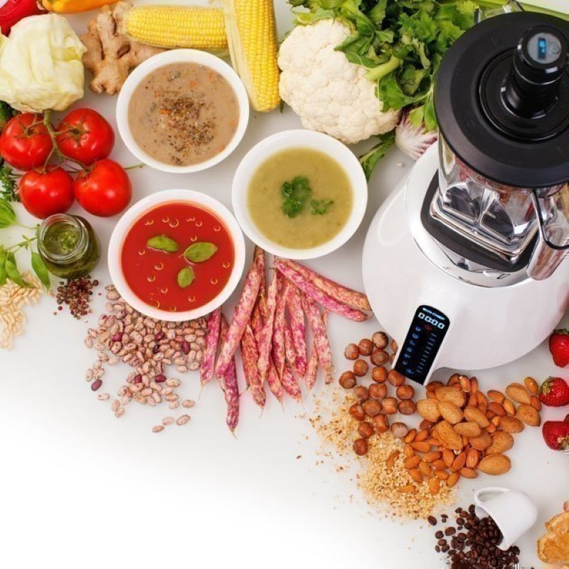 Top view of the BioChef Living Food Blender with vegetables, purees, and nuts surrounding it.