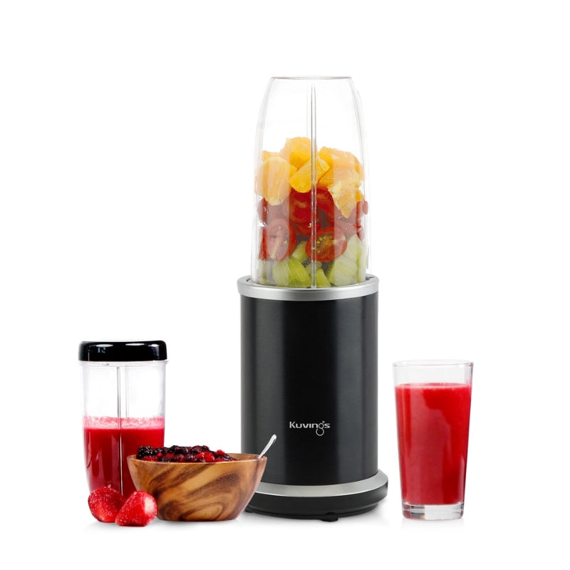 Kuvings Nutri Blender with fruits inside and red juice and a bowl by its side