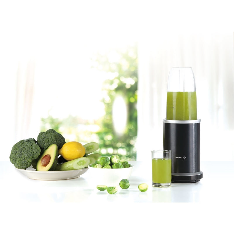 Kuvings Nutri Blender in the kitchen with green smoothie inside and fruits and veggies by its side