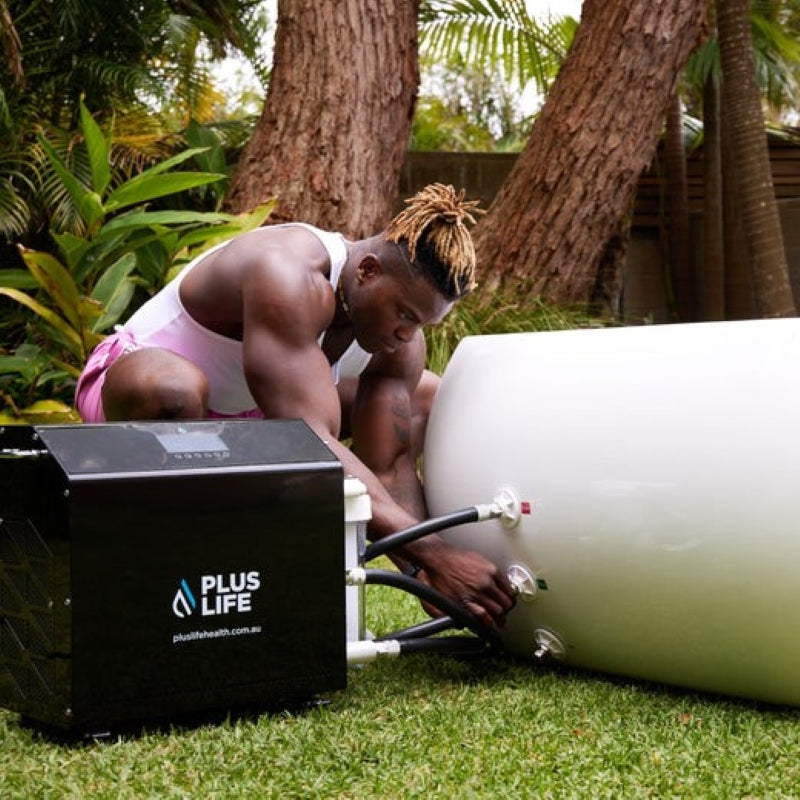 a man installing the PlusLife Commercial XL Ice Bath's chiller