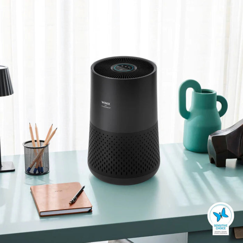 Winix compact air purifier black on desk
